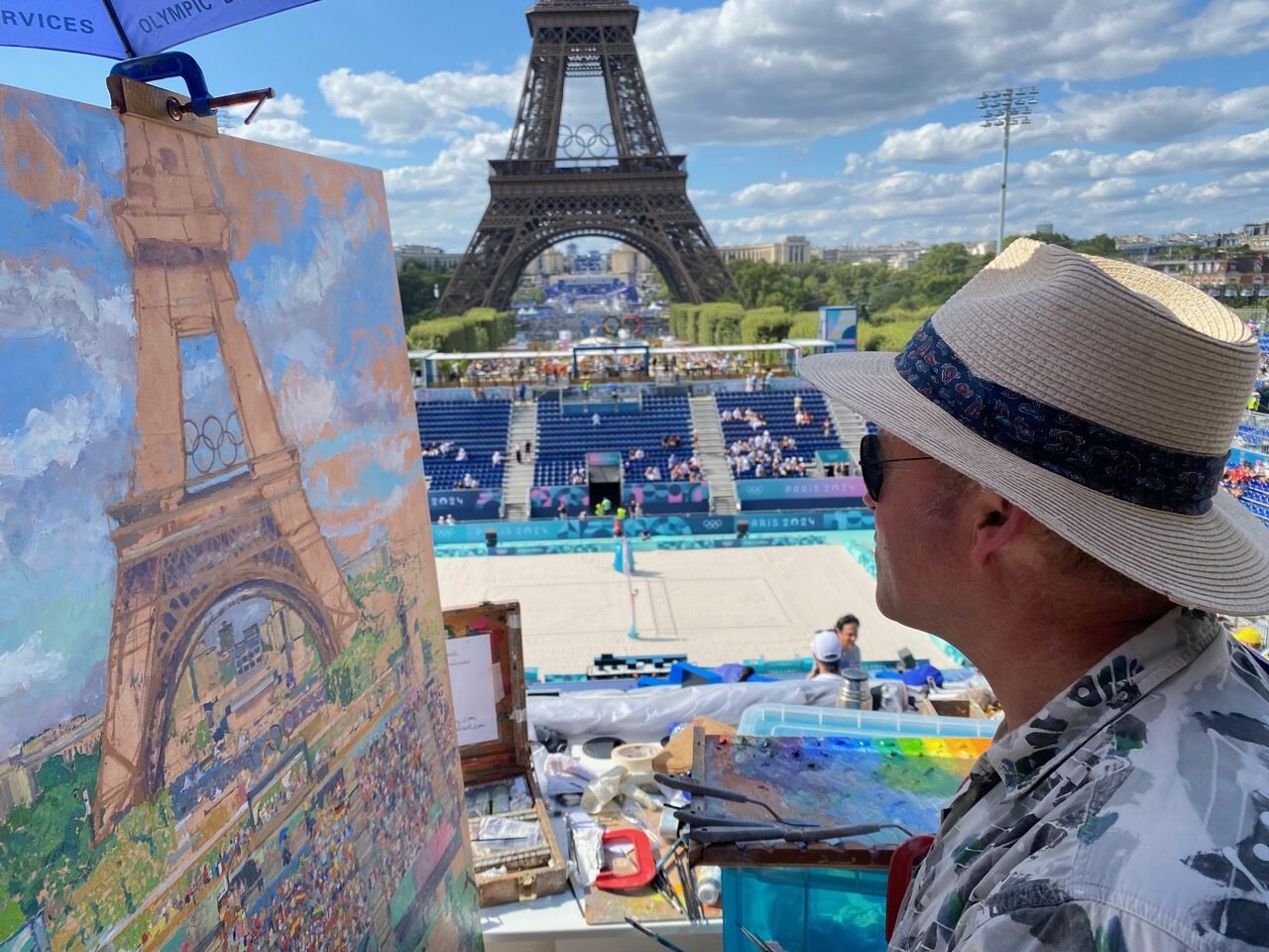 Peter Spens at his easel with the Eiffel Tower behind, Paris Olympics 2024